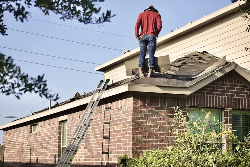 Professional roofer working on a residential roof in Pipesville